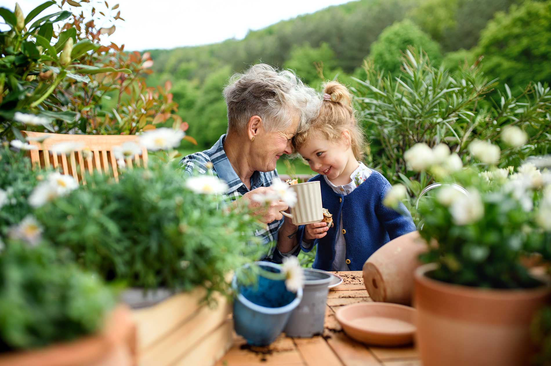 girl and grand mother having coffee together